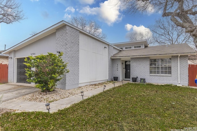 view of front of property with a garage and a front yard