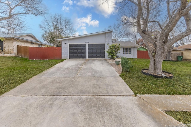 ranch-style house with a garage and a front yard