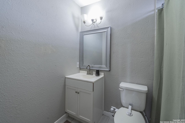 bathroom featuring toilet and vanity