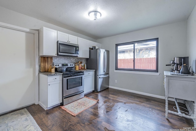 kitchen with white cabinetry, appliances with stainless steel finishes, backsplash, dark hardwood / wood-style flooring, and a textured ceiling