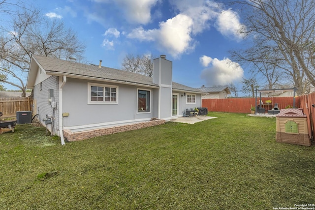 rear view of house with central AC, a yard, and a patio