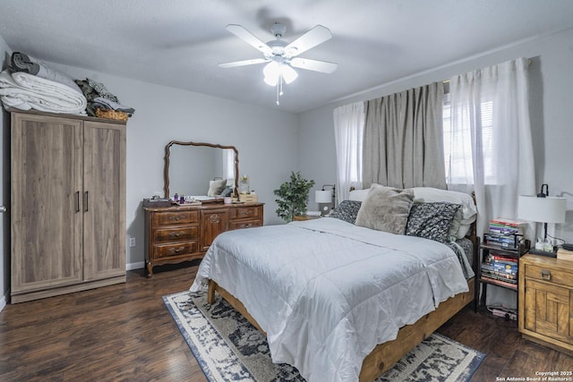 bedroom featuring ceiling fan and dark wood-type flooring