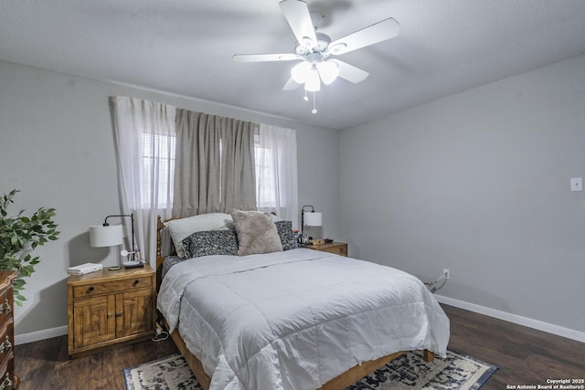 bedroom with ceiling fan and dark wood-type flooring