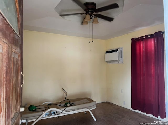 miscellaneous room featuring ceiling fan, an AC wall unit, and hardwood / wood-style flooring