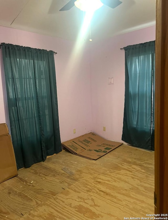 empty room featuring ceiling fan and hardwood / wood-style floors