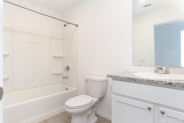 full bathroom featuring hardwood / wood-style flooring, tub / shower combination, toilet, and vanity