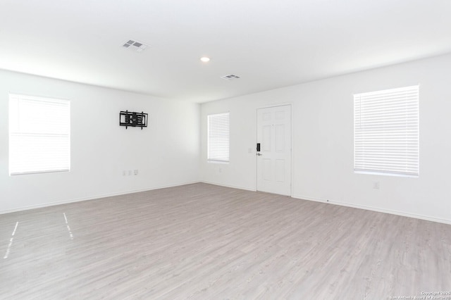 spare room with light hardwood / wood-style floors