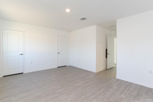 spare room featuring light hardwood / wood-style floors