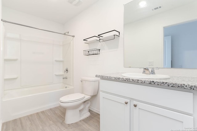 full bathroom with shower / bathtub combination, hardwood / wood-style floors, toilet, and vanity