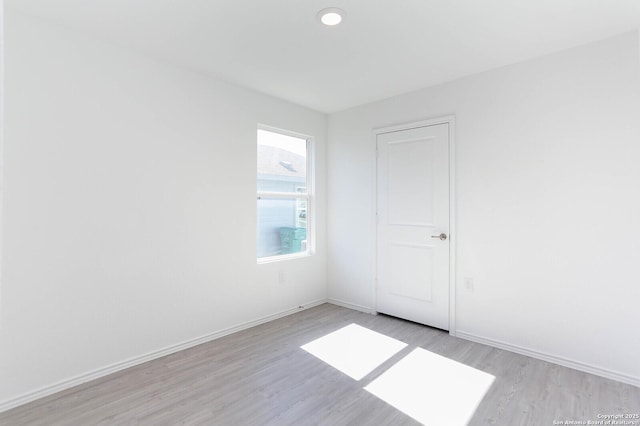 unfurnished room with light hardwood / wood-style flooring