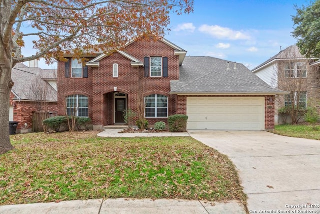 view of property featuring a front lawn and a garage