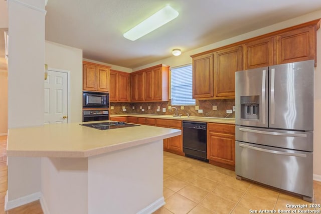 kitchen with backsplash, a kitchen island, black appliances, sink, and light tile patterned floors