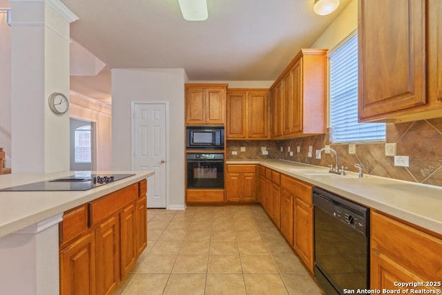 kitchen with light tile patterned flooring, sink, backsplash, and black appliances