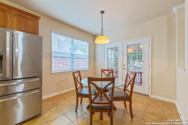 dining space with light tile patterned floors, french doors, and plenty of natural light