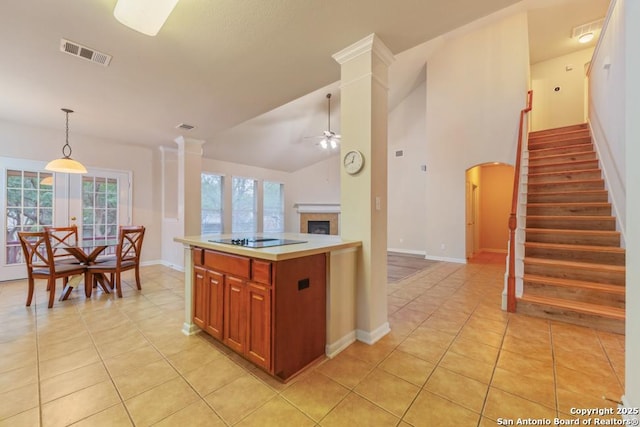 kitchen with ceiling fan, light tile patterned floors, lofted ceiling, and black electric cooktop