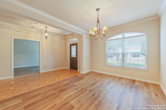 unfurnished room featuring ornamental molding, light hardwood / wood-style flooring, and a notable chandelier