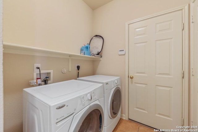 laundry area with light tile patterned floors and separate washer and dryer