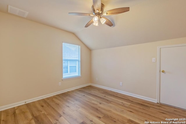 bonus room with light hardwood / wood-style floors, ceiling fan, and vaulted ceiling