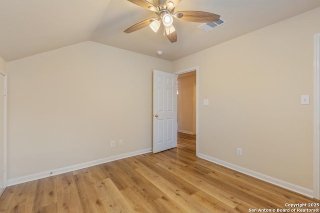 empty room featuring light hardwood / wood-style floors, lofted ceiling, and ceiling fan