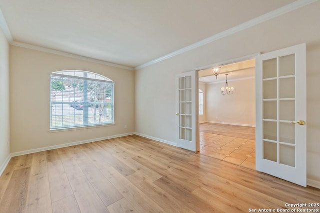 unfurnished room with french doors, an inviting chandelier, crown molding, and hardwood / wood-style floors