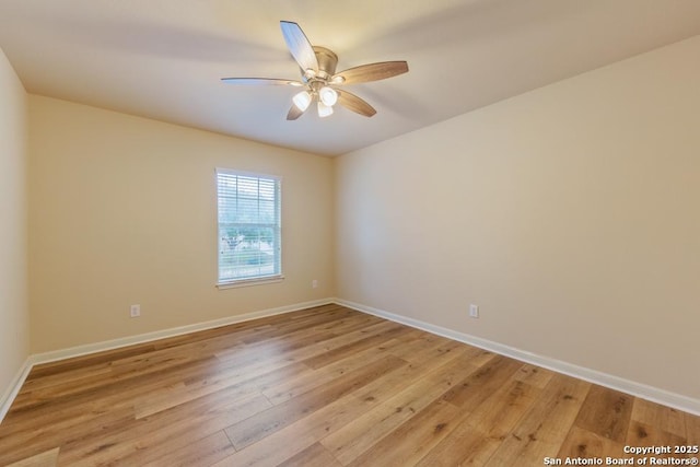 empty room with ceiling fan and light hardwood / wood-style floors