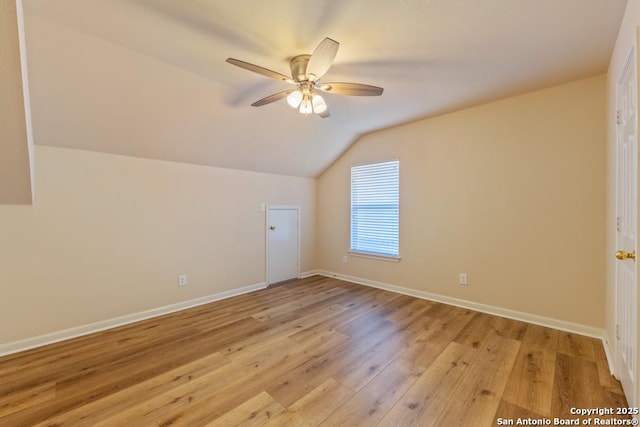 bonus room with ceiling fan, lofted ceiling, and light wood-type flooring