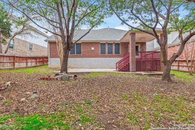 rear view of house with a wooden deck