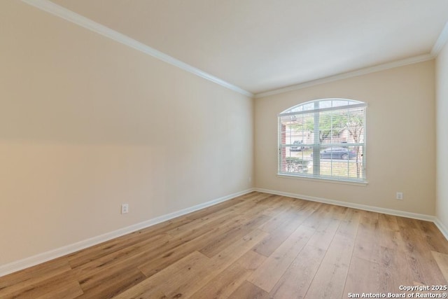 spare room with light hardwood / wood-style flooring and ornamental molding