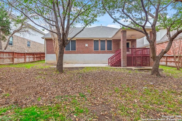 back of property with a wooden deck