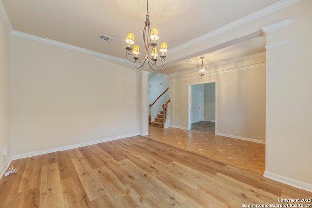 empty room featuring hardwood / wood-style flooring, crown molding, and a notable chandelier