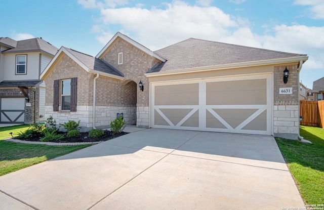 view of front of property with a front yard and a garage