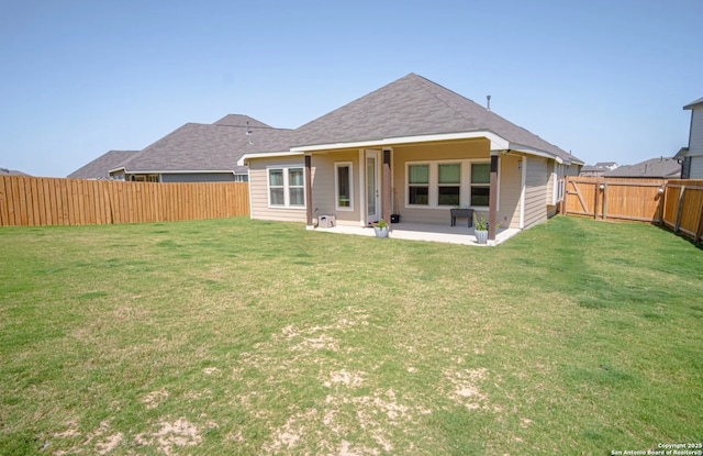 back of house featuring a patio area and a yard