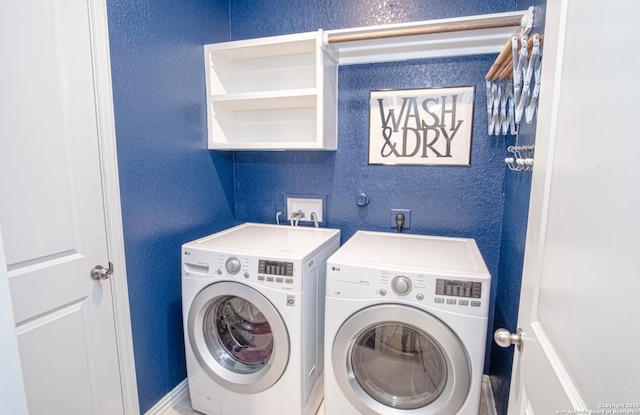 washroom with washing machine and clothes dryer