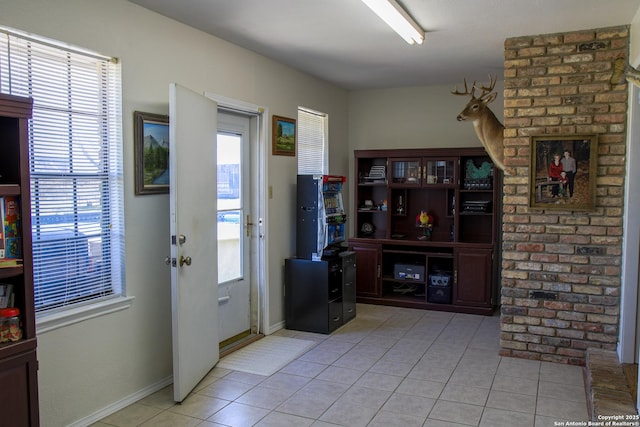 doorway to outside featuring light tile patterned flooring