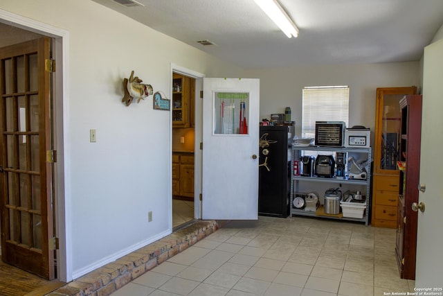 unfurnished room with light tile patterned floors