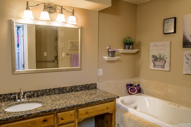 bathroom with vanity and tiled tub