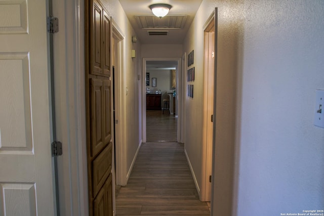 corridor featuring dark hardwood / wood-style floors