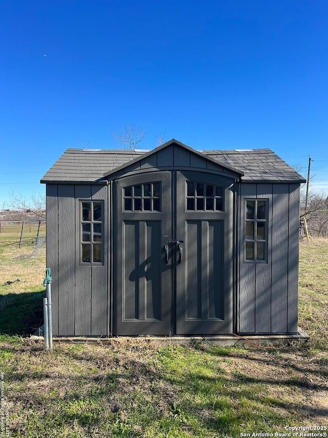 view of outbuilding featuring a lawn