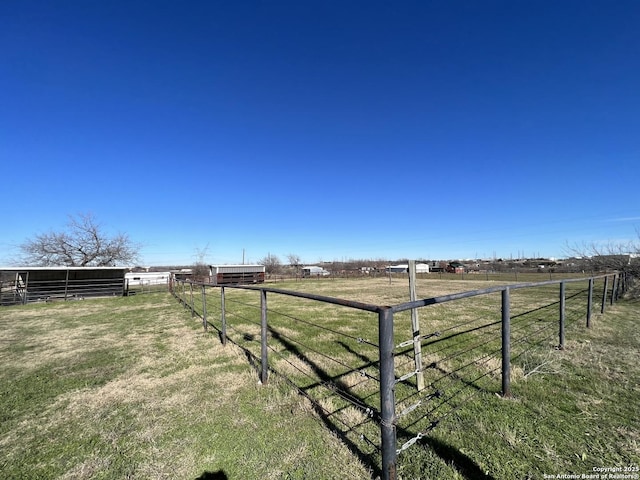 view of yard with an outbuilding and a rural view