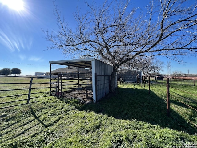 view of yard featuring a rural view and an outbuilding