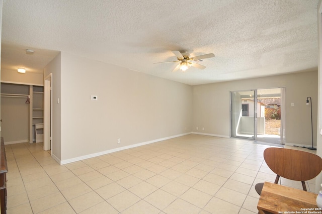 interior space featuring ceiling fan and a textured ceiling