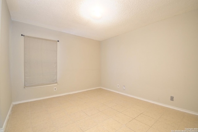 spare room with a textured ceiling