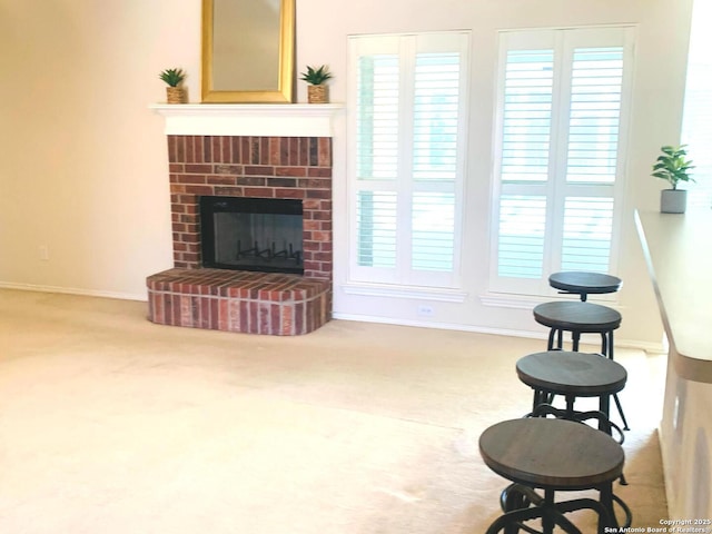 carpeted living room featuring a fireplace