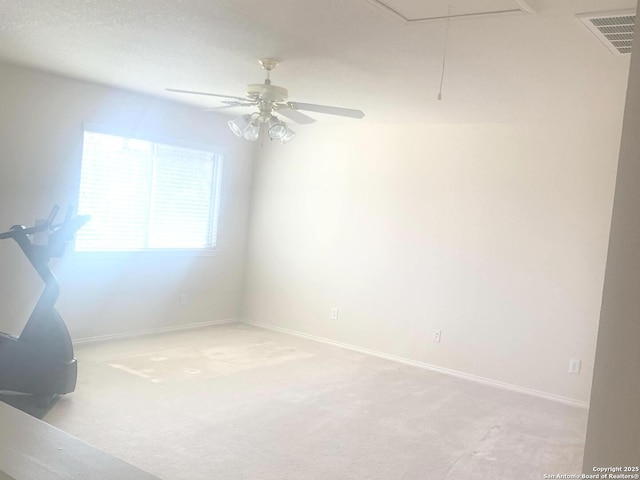 spare room with light carpet and ceiling fan