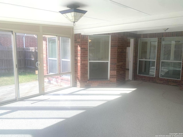 unfurnished sunroom featuring a wealth of natural light