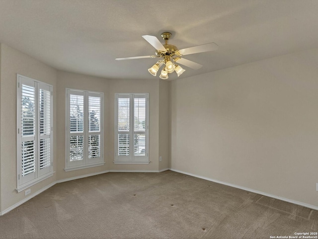 unfurnished room with ceiling fan and light colored carpet