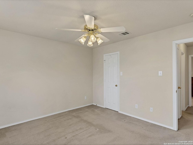 carpeted empty room with ceiling fan