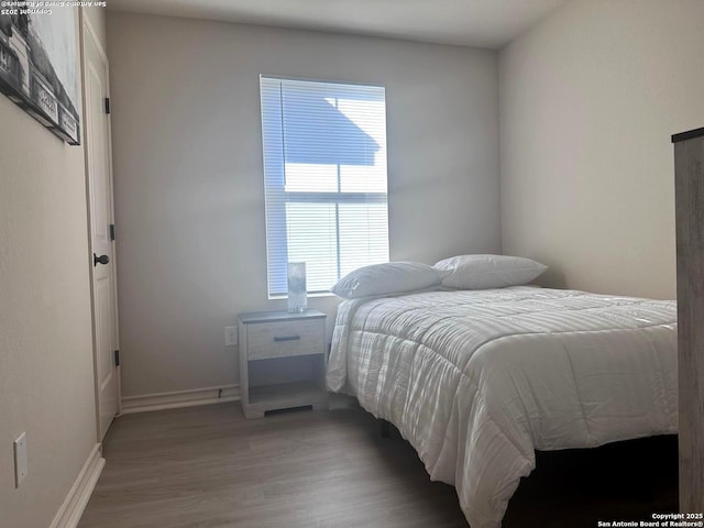 bedroom with wood-type flooring