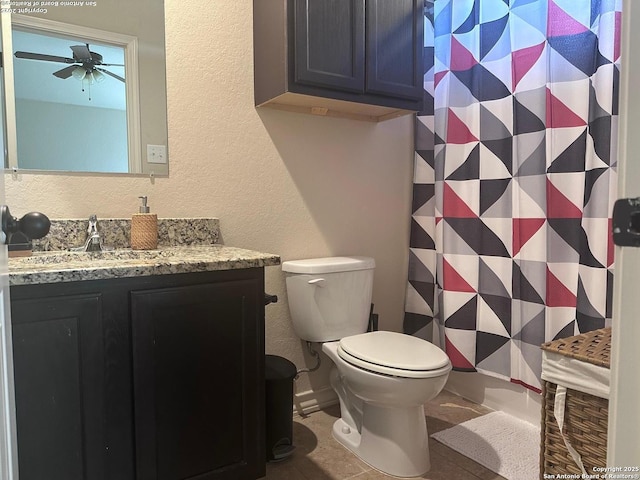 bathroom with ceiling fan, toilet, vanity, and tile patterned flooring