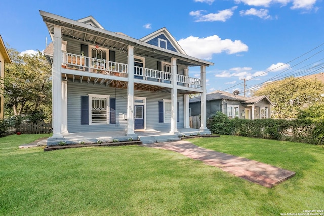 view of front of home featuring a balcony and a front lawn